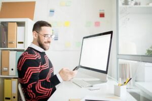 Cheerful manager receiving sms with good news